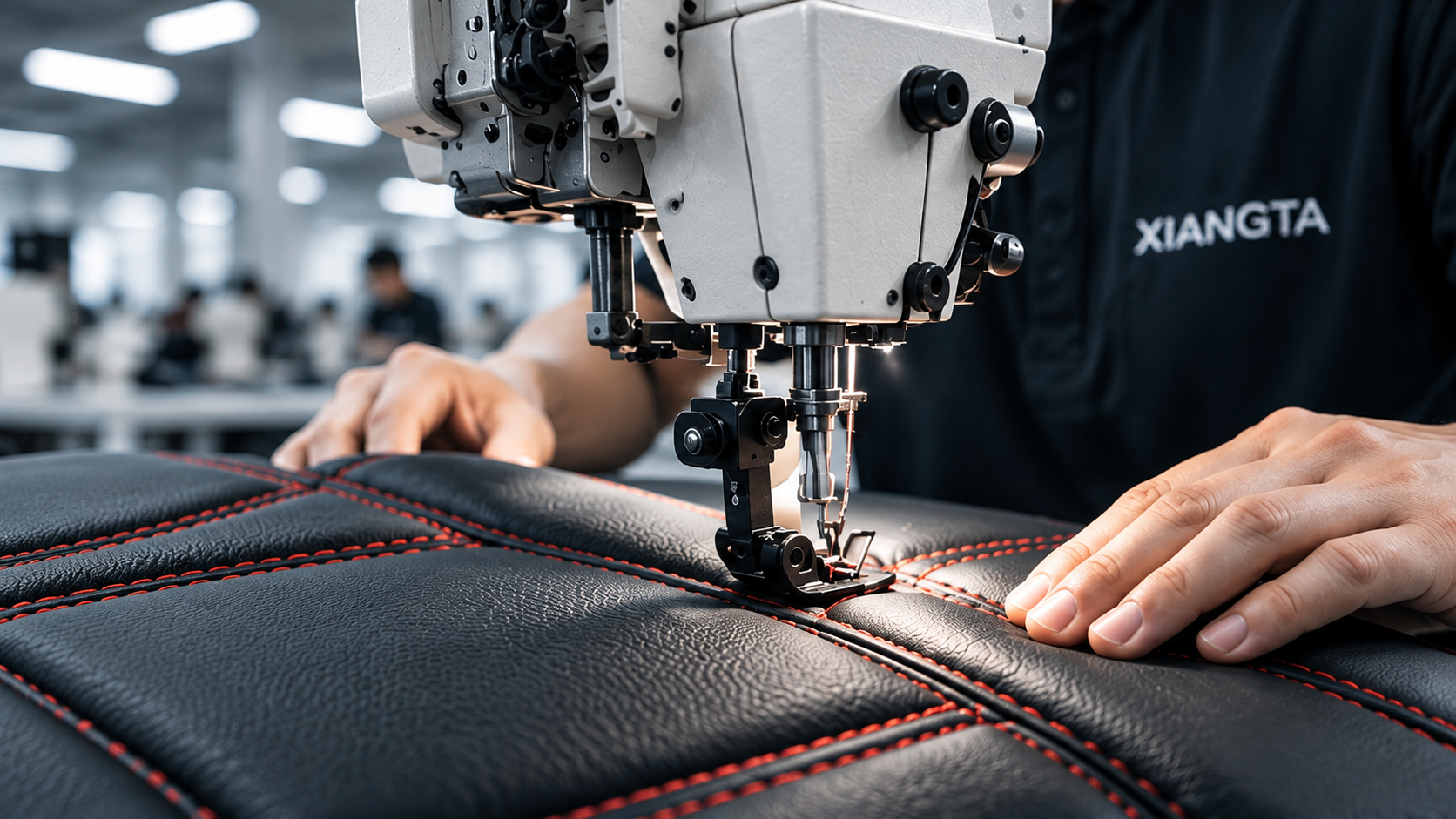 Hands guiding red stitching through a sewing machine